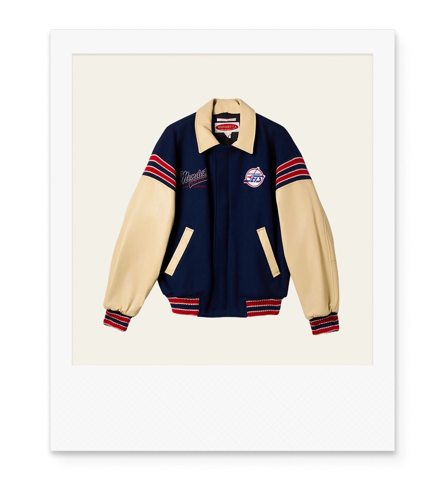 Navy and beige Winnipeg Jets varsity jacket with red stripes on the cuffs and trims.
