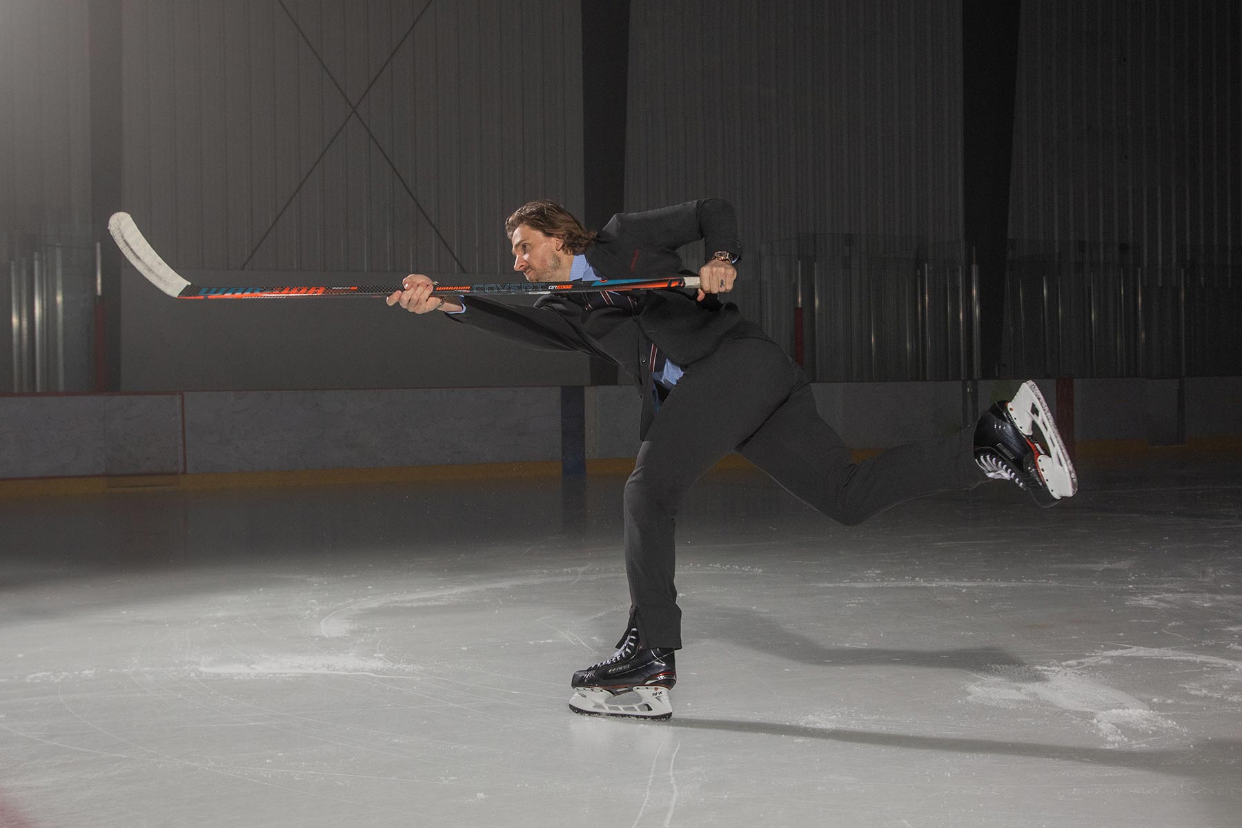 NHL Captain Blake Wheeler doing a slapshot in a Modern Ambition bespoke suit