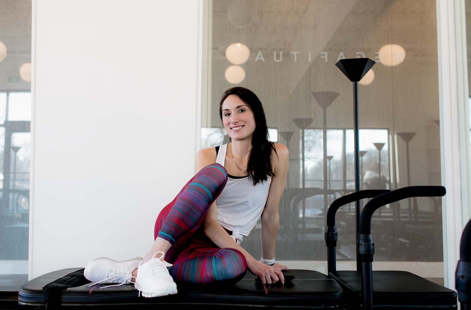 The Fitual founder Chalnessa Eames poses on a Lagree machine