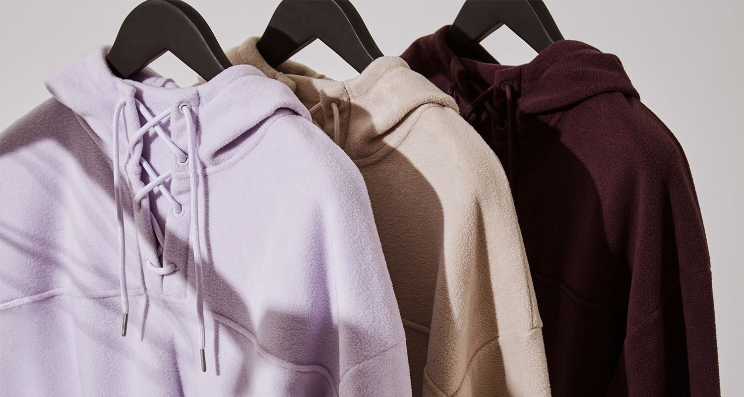 Three MPG hooded sweatshirts on hangers