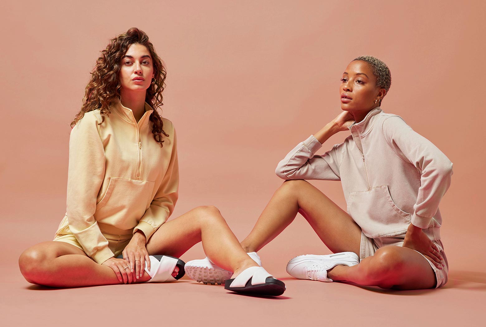 Female MPG models sitting on a studio floor