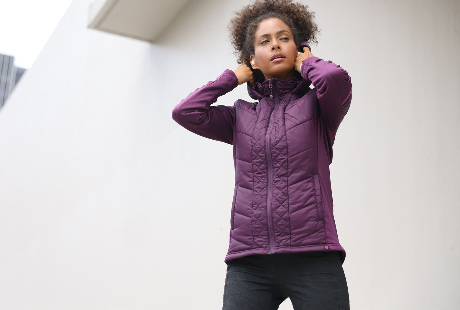 Mondetta female model wearing a purple quilted jacket